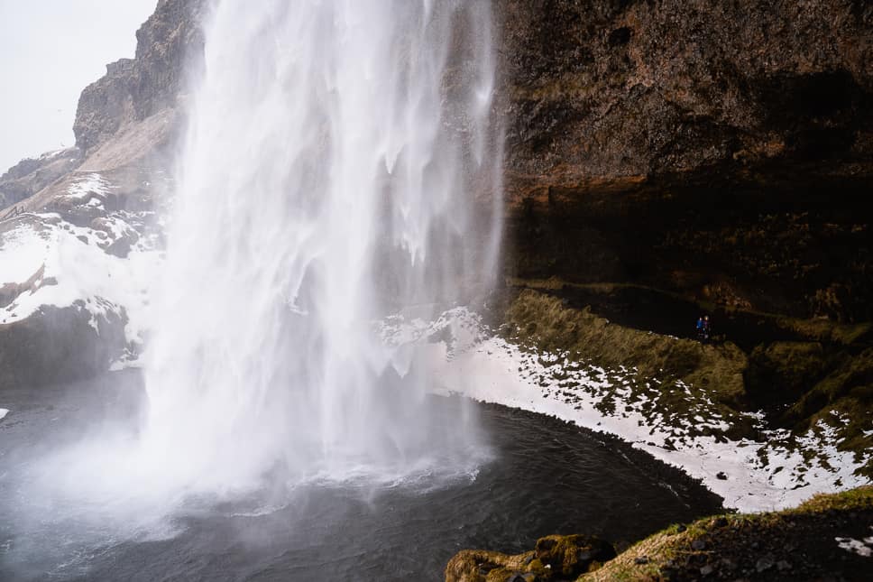 15 best and most impressive things to do in Iceland two kids behind the seljalandsfoss waterfall in iceland