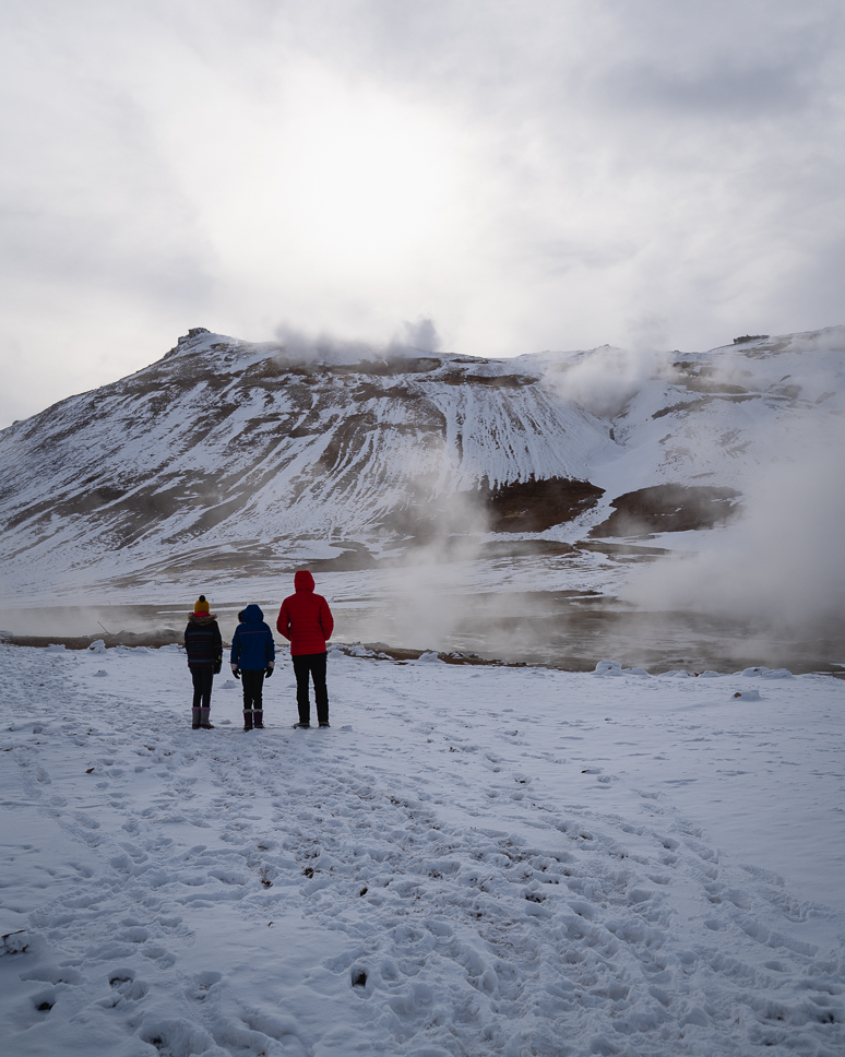 family watching the thermal mud poles in Hverir in North Iceland