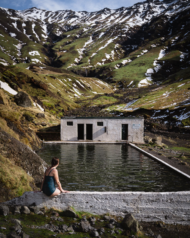 woman bathing in Seljavallalaug in sout island