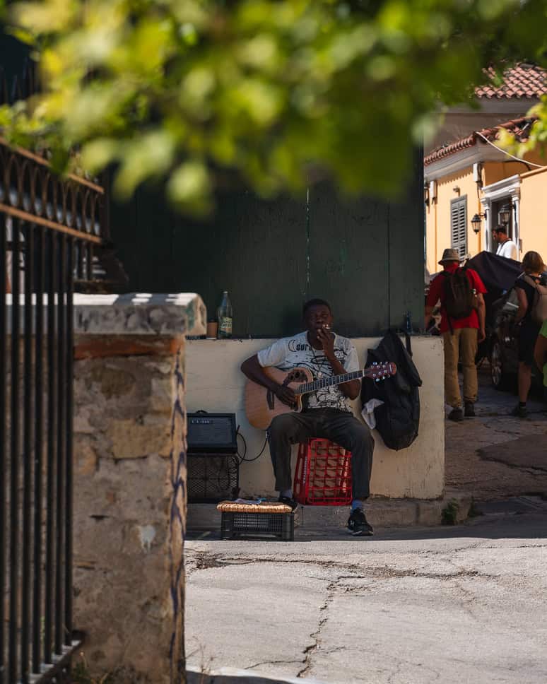 Discover what to do in Athens + the nicest neighborhoods Street musician Athens