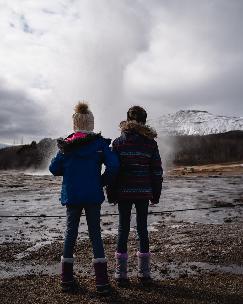 The best things to do in Reykjavik, Iceland + TIPS two kids watching geysir during a golden circle tour in iceland