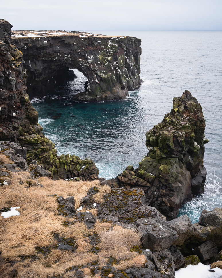 Snaefellsnes Peninsula in Iceland: the best things to do + itinerary Black cliffs and rock formations by the sea in Snaefellsnes, Iceland