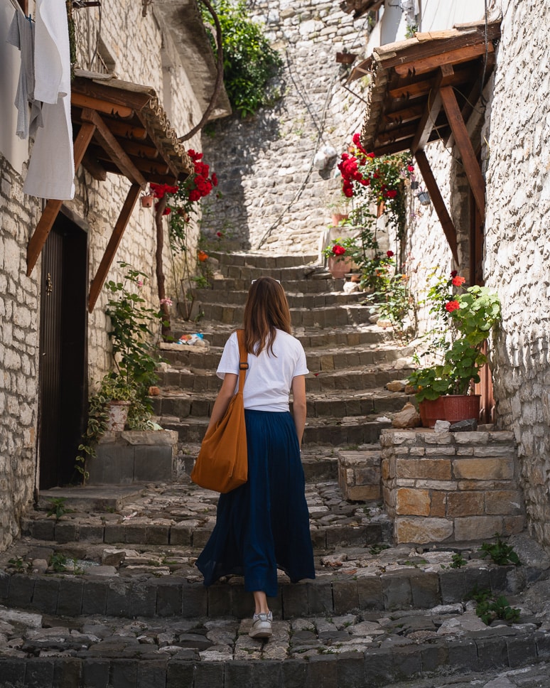 Albania road trip: our ultimate itinerary for 10 days to 3 weeks a girl in the streets of berat