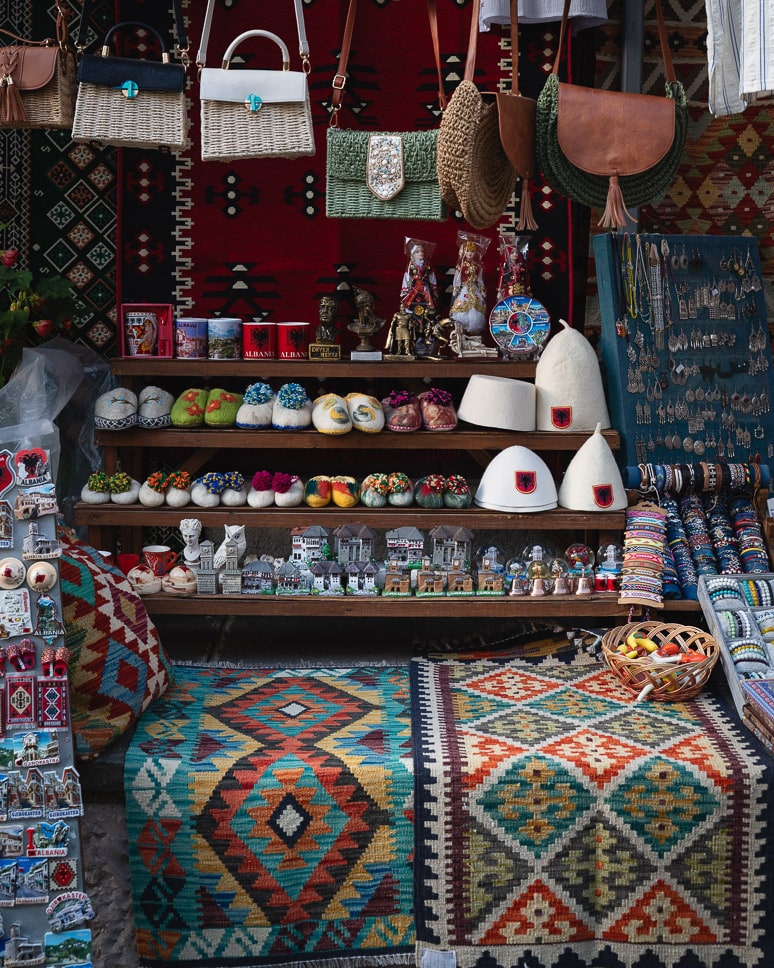 Albania road trip: our ultimate itinerary for 10 days to 3 weeks a shop on the market in Gjirokaster