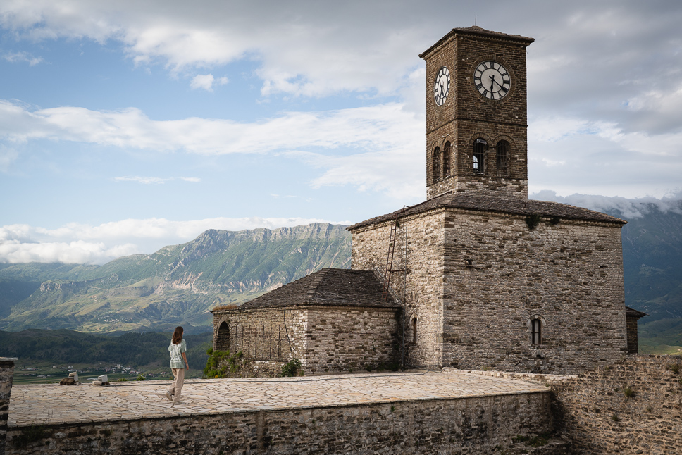 Albania road trip: our ultimate itinerary for 10 days to 3 weeks Girl walking to Gjirokaster Castle Clocktower in Albania Itinerary