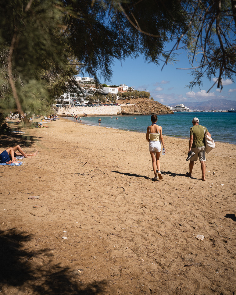 What to do in Paros, Greece: complete travel guide + 4-day itinerary family walking on the beach of Piso Livadi
