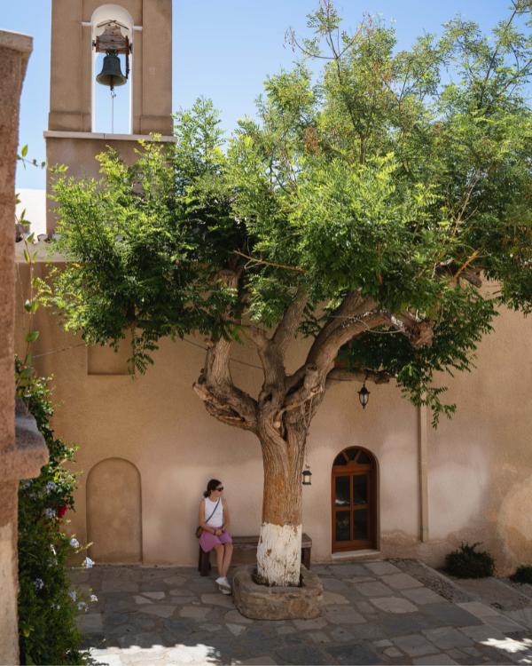 What to do on Syros: Our favourite island in the Cyclades Girl on a bench on a square in Ano Syros
