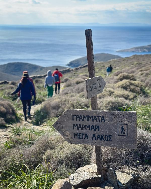 What to do on Syros: Our favourite island in the Cyclades Group of hikers on their way to Americano Beach in Syros.