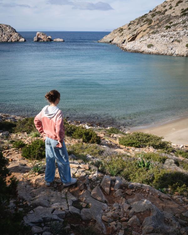 What to do on Syros: Our favourite island in the Cyclades Woman with a view of Barbarossa Beach in Syros.