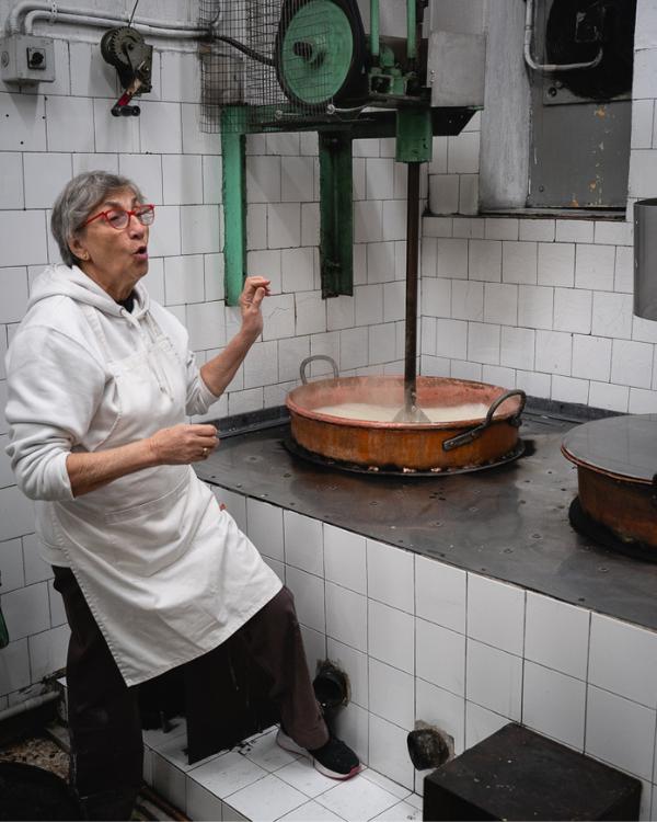 What to do on Syros: Our favourite island in the Cyclades Woman making loukoumi in Syros and explaining the process