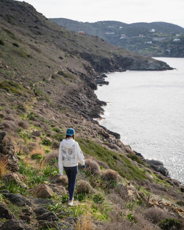 What to do on Syros: Our favourite island in the Cyclades Woman on the coastal path from Delphini Beach to Kini Beach in Syros