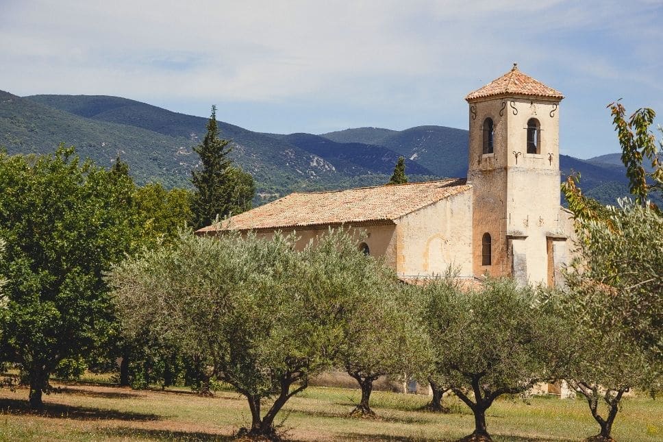 Road trip in South France: Our ultimate itinerary through Southern France view of a monastery with olive trees in the provence