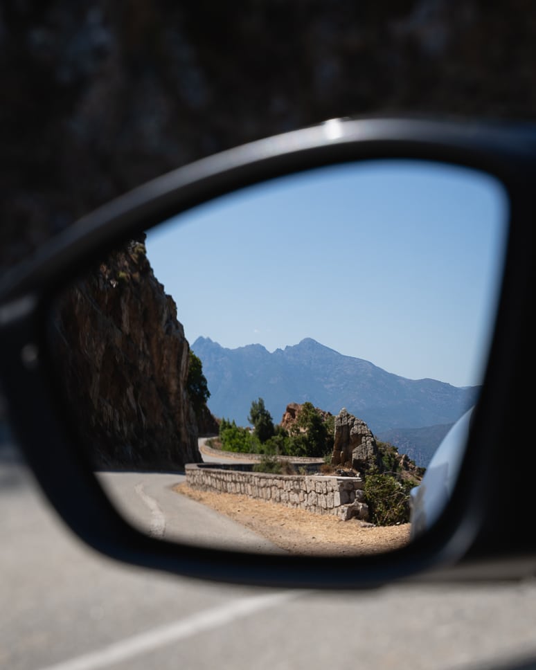 Car rental in Corsica: everything you need to know (+ our own experience driving in Corsica) View of the winding mountain roads in Corsica from the rental car
