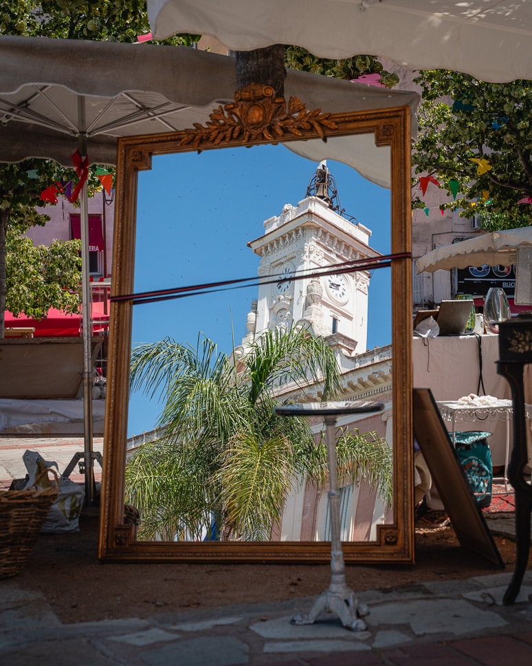 Reflection of the town hall at the flea market on Place Foch in Ajaccio.