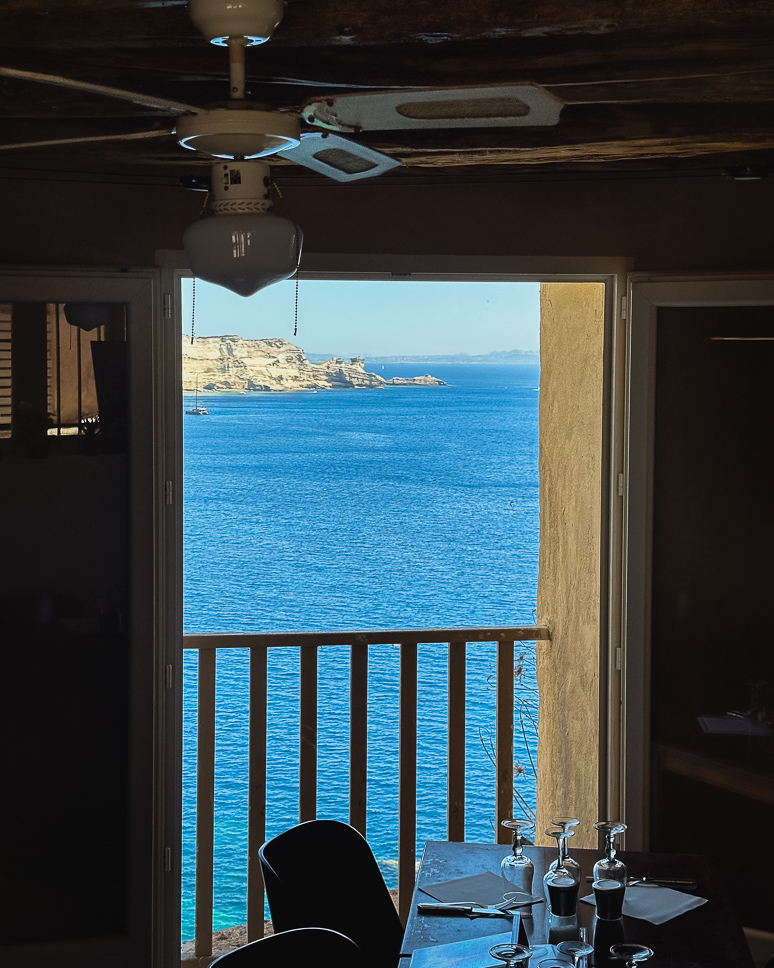 View of the white cliffs of Bonifacio from a restaurant terrace